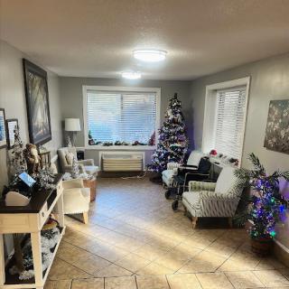 A charming living room decorated for the holiday season, complete with a festive Christmas tree and warm accents.