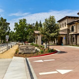 Entrance to The Terraces with landscaped surroundings and clear signage.