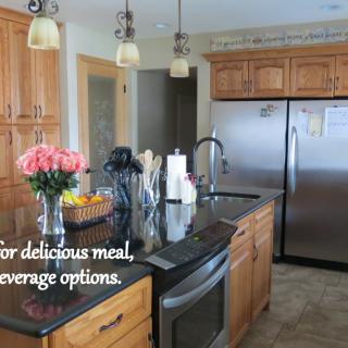 A modern kitchen with stainless steel appliances and a central island adorned with fresh flowers.