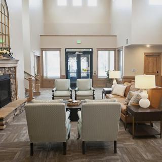 A cozy living room with comfortable seating and a fireplace.