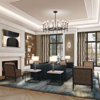 A modern living room featuring elegant furniture, a central chandelier, and large windows.