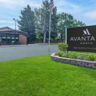 Entrance sign of Avanta hotel with well-maintained landscaping.