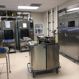 A clean and organized commercial kitchen featuring industrial-grade stainless steel appliances.