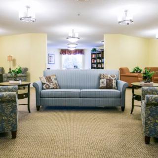 A cozy and well-furnished living room with sofas and armchairs.