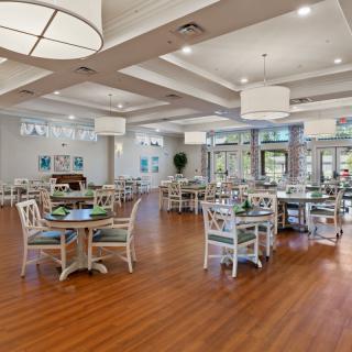 A spacious dining area with modern decor and wooden flooring.