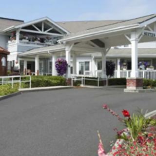 A large building with a covered entrance and well-maintained landscaping.