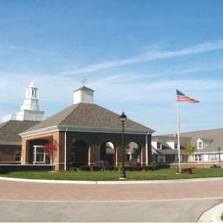 A community center with a flag pole under a clear blue sky.
