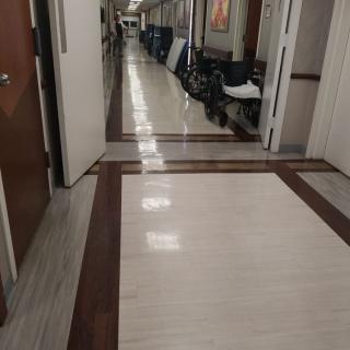 A hospital corridor with wheelchairs lining the side.