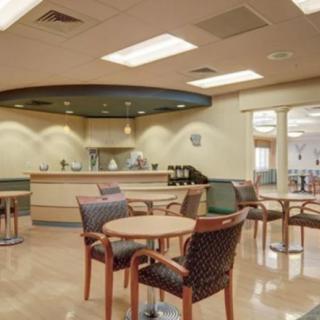 A cozy cafe interior with tables and chairs arranged for seating.