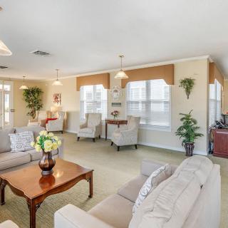 A spacious living room with comfortable seating, large windows, and elegant decor.