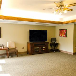 A spacious living room with a large television, comfortable seating, and tasteful decor.