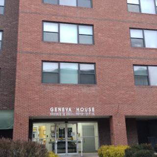 The exterior of a dental office building featuring a brick facade and large windows.