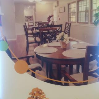 A cozy dining area with a set table and wooden chairs.