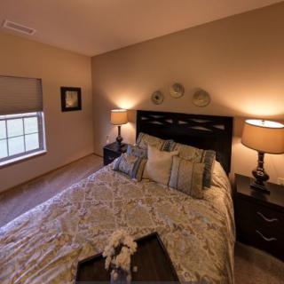 A cozy bedroom with warm lighting and elegant decor.