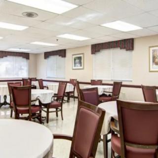 A spacious dining area with neatly arranged tables and chairs.