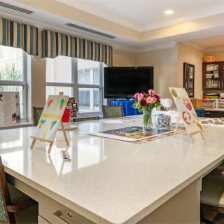 A modern kitchen interior with a large central island and bright decor.
