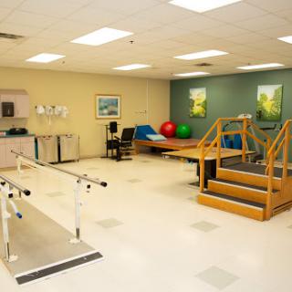 A well-equipped physical therapy room featuring exercise equipment and rehabilitation tools.