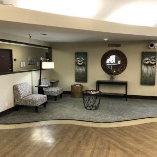 A cozy lobby area with seating and decorative elements.
