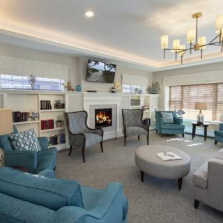 A cozy and modern living room with a fireplace and comfortable seating.