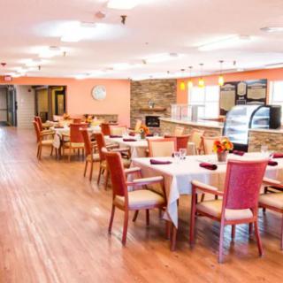 A modern dining area with neatly arranged tables and chairs.