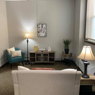 A cozy living room with comfortable seating and soft lighting.