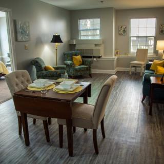 A cozy living and dining area featuring modern furniture and bright lighting.