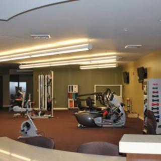 A spacious gym with various exercise equipment and workout machines.