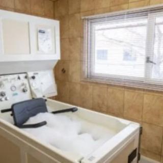 A room featuring hydrotherapy equipment with a bubbling water tub for therapeutic use.