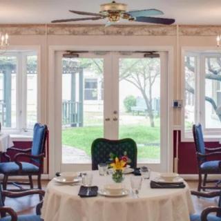A beautifully set dining room table with elegant decor and large windows providing natural light.