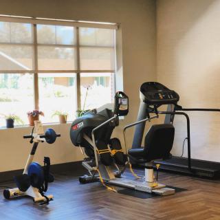 A small gym area with various exercise machines.