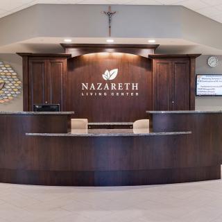 A reception desk at Nazareth Living Center with a modern, wooden design.