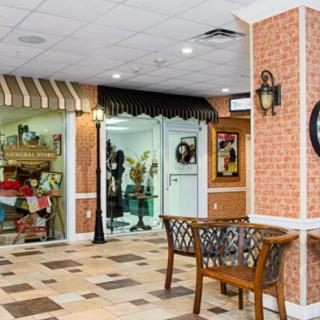 A cozy lobby area with shops and benches for seating.