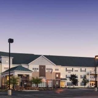A hotel building exterior photographed during the evening.