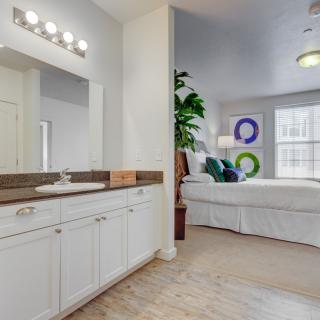 A modern open-concept bedroom and bathroom space featuring stylish decor and furnishings.