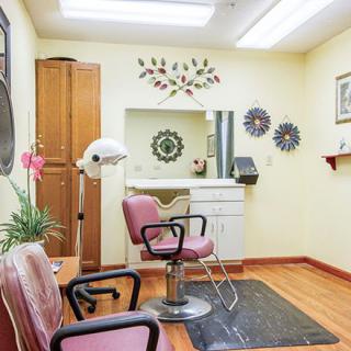 A cozy hair salon featuring barber chairs, mirrors, and decorative elements on the walls.