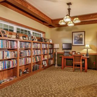 A cozy study room with bookshelves and a wooden desk.