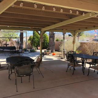 A spacious backyard patio with a pergola and outdoor seating arrangement.