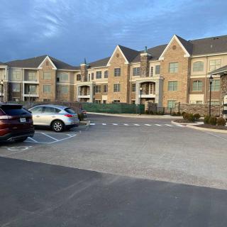 A suburban apartment complex with parked cars in the evening light.