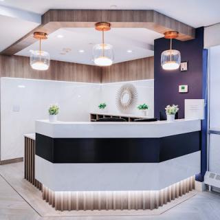 A modern reception desk with stylish lighting and minimalist decor.