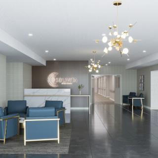 A modern lobby featuring stylish blue furniture and elegant lighting.