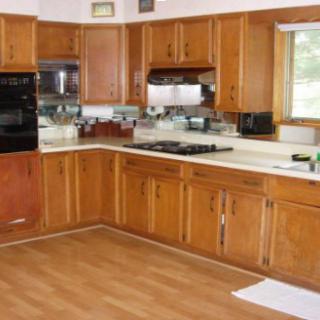 A spacious kitchen with wooden cabinets and modern appliances.