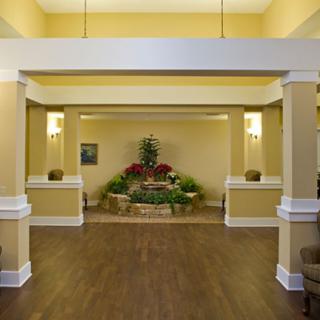 A cozy lobby interior with plants and warm lighting.