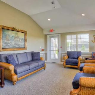 A cozy living room with comfortable seating and warm lighting.