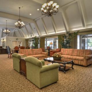 A spacious lobby with comfortable sofas and elegant chandeliers.
