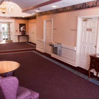 A cozy lobby with carpeted floors and comfortable seating.