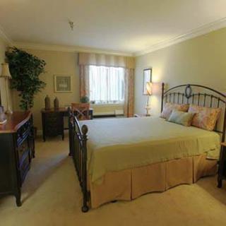 A cozy bedroom with elegant furnishings and natural lighting.