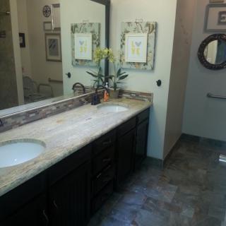 A well-decorated bathroom with a double sink and large mirror.