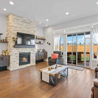 A modern living room with a fireplace and large sliding glass doors providing ample natural light.