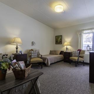 A cozy living room with comfortable seating and warm lighting.