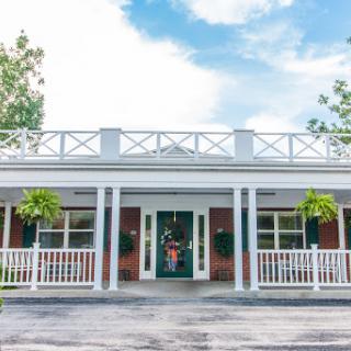 A charming facade of a house showcasing classic architectural features and inviting landscaping.